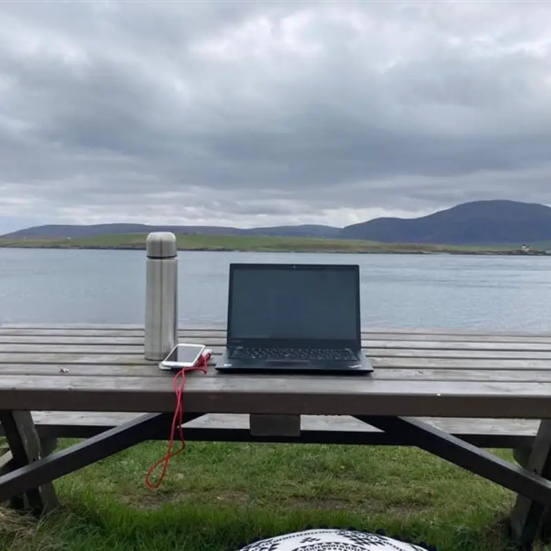 Work. Life. Smarter. Laptop beside a lake